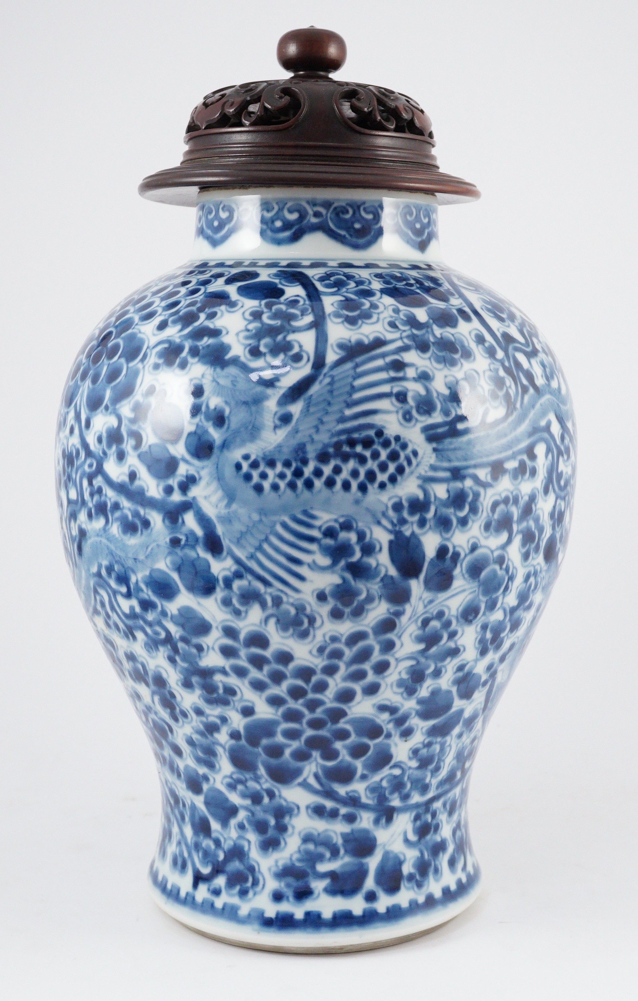 A Chinese blue and white ‘phoenix and peony’ baluster jar, Kangxi period, with a later wood cover, 36cm high excluding later wood cover
